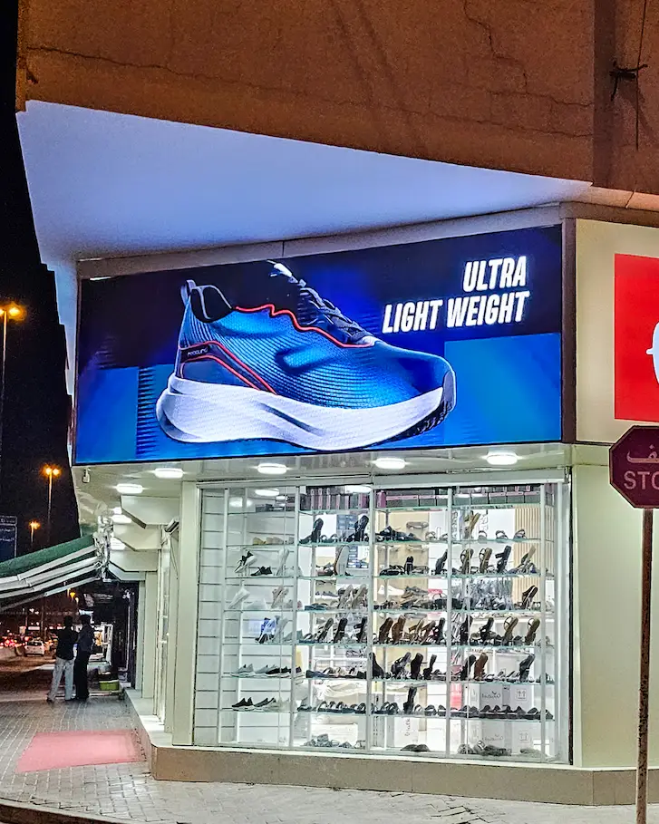 Outdoor LED screen displaying advertising content outside a retail store
